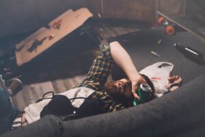 Man passed out on couch after consuming too much alcohol at social event
