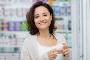 Woman holding medication container in pharmacy to represent Seroquel