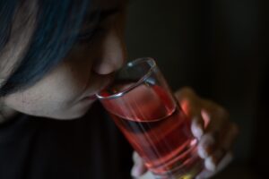 Woman drinking alcohol after taking trazodone for depression