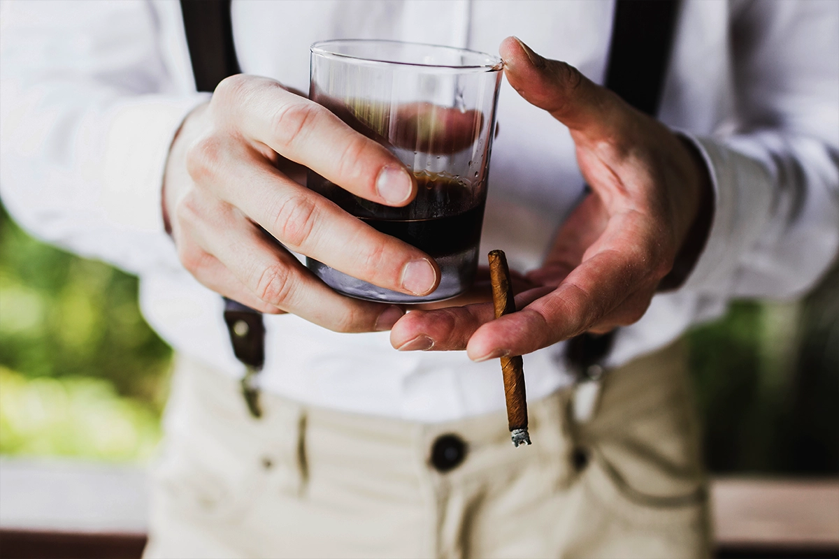 Man holding a glass of whiskey